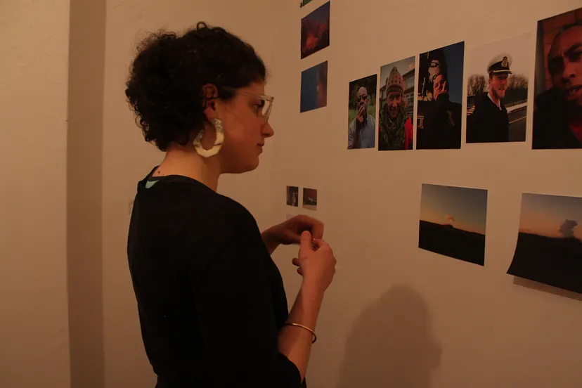 The hotbe art curator looking at photos on a wall